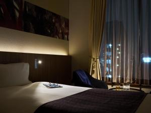 a hotel room with a bed and a window at Millennium Mitsui Garden Hotel Tokyo - Ginza in Tokyo