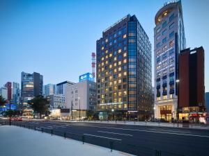 a city street with tall buildings in a city at Millennium Mitsui Garden Hotel Tokyo - Ginza in Tokyo