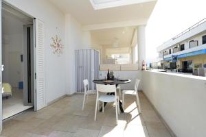 a small dining room with a table and chairs at Le Luminarie Lido Marini in Lido Marini +7 photos