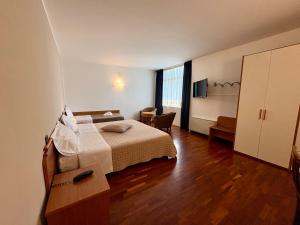 a hotel room with a bed and a television at Sole della Franciacorta - Hotel & Restaurant in Capriolo +57 photos