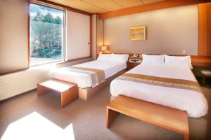 Postel nebo postele na pokoji v ubytování Hakone Kohaku Onsen Hotel 箱根琥珀温泉ホテル
