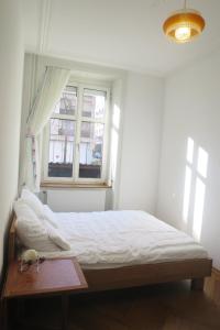 a bedroom with a bed and a window at inHere-outThere in Basel +10 photos