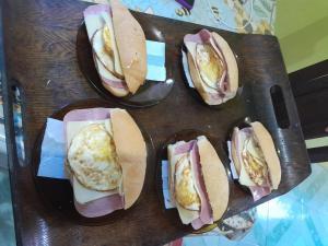 a group of sandwiches on plates on a table at Hospedagem Chapéu Virado in Belém