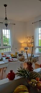 a kitchen with a table with fruits and vegetables on it at Chalet Trolio bed & breakfast in Alhendín