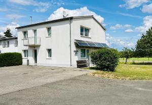 a white house with solar panels on it at Monteur Unterkunft 6 Betten in Karben