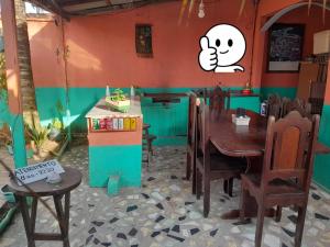 a dining room with a table and a toy house at Hospedagem Chapéu Virado in Belém