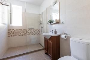 a bathroom with a toilet and a sink and a shower at Montana Studios in Braşov