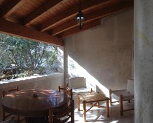 a dining room with a table and chairs on a porch at Il GIARDINO della FALENA in Favignana
