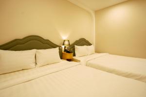 Postel nebo postele na pokoji v ubytování Ngọc Minh Châu Hotel