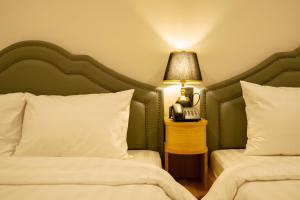 Postel nebo postele na pokoji v ubytování Ngọc Minh Châu Hotel