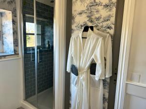 a robe hanging on a door in a bathroom at Nana Mac Chambre D'hôtes in Limalonges +62 photos