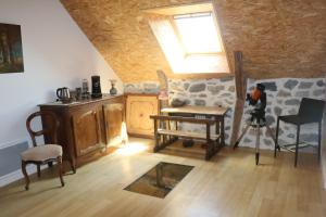 a living room with furniture and a skylight at La Fermette de Loucheyre in Saint-Amandin +29 photos