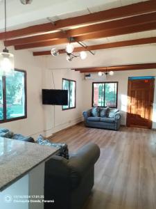 a living room with a couch and a tv at Finca Agroturística La Amistad in Churuquita Grande +32 photos