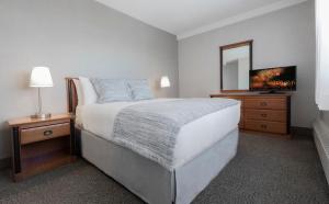 Cama ou camas em um quarto em L'Appartement Hôtel