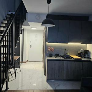 a kitchen with a sink and a counter top at Apartament Wrocław Promenady in Wrocław +4 photos