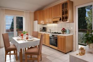 a kitchen with a table and a dining room at Palmaja in Kaštela