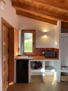 a kitchen with a black and white counter and a window at San Bartolomé Etxea 2 in Ea