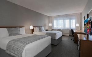 Cama ou camas em um quarto em L'Appartement Hôtel
