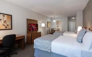 Cama ou camas em um quarto em L'Appartement Hôtel