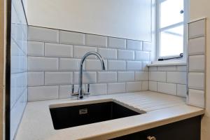 a kitchen with a sink and a window at Finest Retreats - Centre View in Sidmouth +19 photos