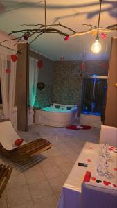 a large bathroom with a tub in a room at Andale SuiteSpa in Villa Badessa +38 photos