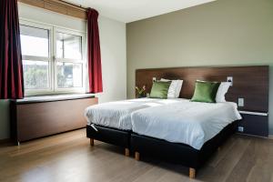 Voodi või voodid majutusasutuse Hotel Falko toas