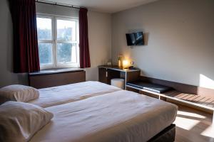 Voodi või voodid majutusasutuse Hotel Falko toas