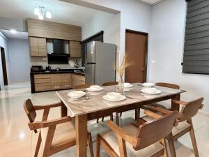 a kitchen and dining room with a wooden table and chairs at The Paloh Town Suites 4R2B with 2 carpark by IWH Suites in Ipoh