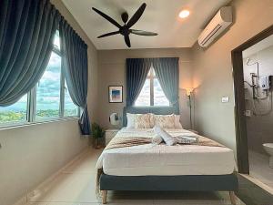 a bedroom with a bed and a ceiling fan at The Paloh Town Suites 4R2B with 2 carpark by IWH Suites in Ipoh