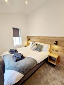 a bedroom with a large bed with towels on it at The Old Bakehouse in Ulverston