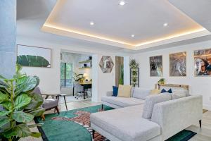 a living room with a couch and a table at Villa Verde Miami in Miami +5 photos