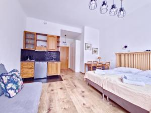 a large room with two beds and a kitchen at Apartamenty Velvet in Poznań