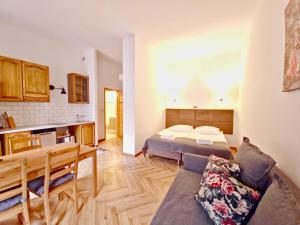 a living room with a bed and a kitchen at Apartamenty Velvet in Poznań +88 photos