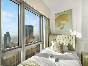 a bedroom with a bed and two large windows at Grande Signature 2 Bedroom Apartments I Persian Gulf Views I Free Parking, Gym, Pool, Wi-Fi & PS5 I by Skyline Serenity in Dubai +52 photos
