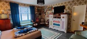 a bedroom with a bed and a tv in it at B&B Västralandet in Sävsjö