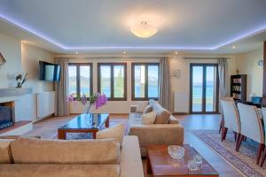 a living room with a couch and a table at Buena Vista Villa - Amazing sea view in Lygia