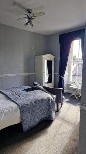 a bedroom with a bed and a ceiling fan at New Hall Bank in Bowness-on-Windermere