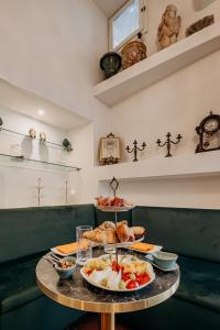a table with two plates of food on it at Palazzo Giunta - Porta Marina Ortigia in Syracuse +82 photos
