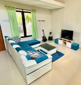 a living room with two couches and a tv at Villa Bromo in Kasri