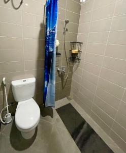 a bathroom with a toilet and a shower at Villa Bromo in Kasri