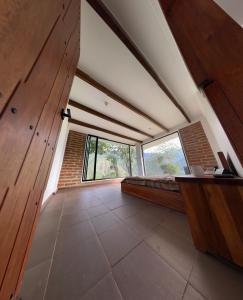 a large room with a bed and a large window at The Cloud Forest Retreat in Pelagallo +14 photos
