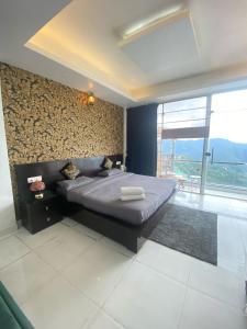 ein Schlafzimmer mit einem Bett und einem großen Fenster in der Unterkunft Parimahal Cottage in Shimla