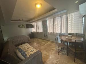 a living room with a table and a dining room at IVT Condo in San Juan