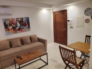 a living room with a couch and a table at luxury marsa beach 2 in La Marsa