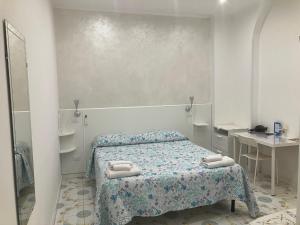 a bedroom with a bed with towels on it at Albergo Oasi in Naples