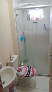 a bathroom with a shower and a toilet and a sink at Ap close cop30 confort in Ananindeua