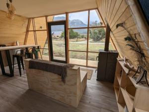 a large room with a large window and a table at OUTSCAPE I Estero I Wifi I Escalada I Cerro Castillo in Villa Cerro Castillo