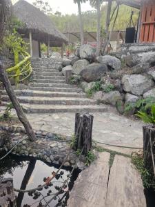 a set of stone stairs with a rock wall at cabañas zona verde tayrona in Santa Marta