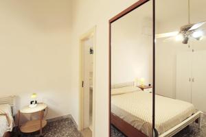 a bedroom with a mirror and a bed at Casa vacanze LuGi by Apulia home in Torre San Giovanni Ugento