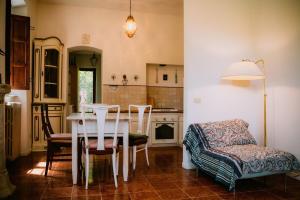 a kitchen with a table and chairs and a couch at Villa Bianca charming Tuscany house with pool in Lucca